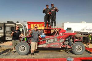 randy raschein and team on podium after winning utv unlimited class at the bitd bluewater desert challenge off-road race
